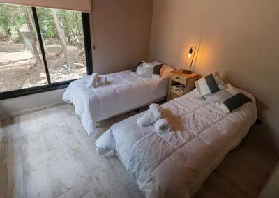 two beds in a room with a window at Finca del Campito in Villa Berna