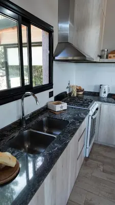 a kitchen with a sink and a stove at Finca del Campito in Villa Berna