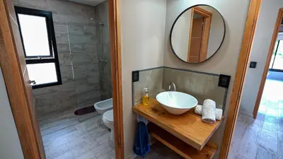 a bathroom with a sink and a toilet and a mirror at Finca del Campito in Villa Berna