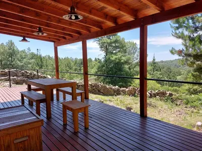 a wooden deck with a table and benches on it at Finca del Campito in Villa Berna