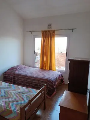 a bedroom with two beds and a window at Departamento Barrio Escuela in Río Tercero