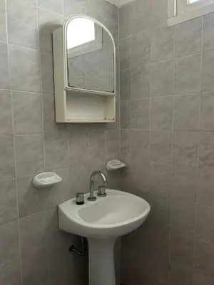 a bathroom with a sink and a mirror at Aiken Embalse in Embalse