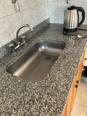 a stainless steel sink in a kitchen counter at Aiken Embalse in Embalse