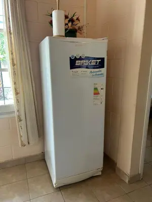 a white refrigerator in a corner of a room at Aiken Embalse in Embalse