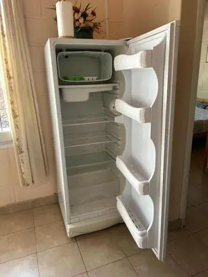 an empty refrigerator with its door open in a kitchen at Aiken Embalse in Embalse