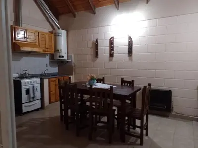 a kitchen with a table and chairs and a stove at Aiken Embalse in Embalse