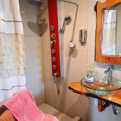 a bathroom with a sink and a shower at departamentos valle escondido in Villa Yacanto