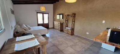 a living room with a couch and a table at Habitare Departamentos in Los Reartes
