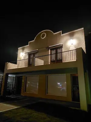 a building with a balcony on the side of it at Habitare Departamentos in Los Reartes
