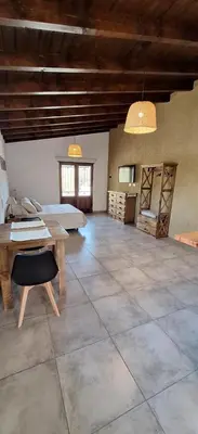 a large room with a bed and a table at Habitare Departamentos in Los Reartes