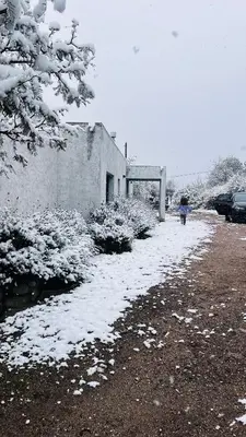 a person walking down a snow covered driveway at Sol & Río Refugio Serrano in Villa de Las Rosas