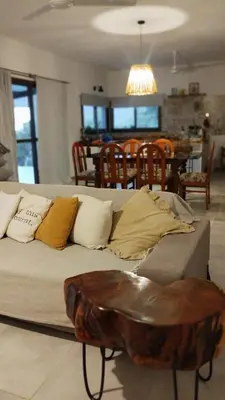 a couch with pillows and a table in a room at Sol & Río Refugio Serrano in Villa de Las Rosas