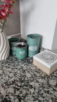 a counter with three green buckets and a book at Garage y Gimnasio Depto Ideal Villa Dolores in Villa Dolores
