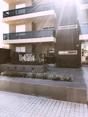 a building with a sign on the side of it at Garage y Gimnasio Depto Ideal Villa Dolores in Villa Dolores