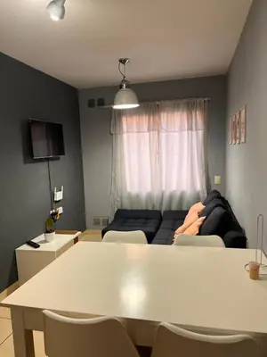 a living room with a table and a couch at Urban loft in Cordoba