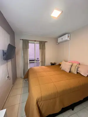 a bedroom with a large bed and a television at Urban loft in Cordoba