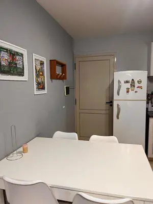 a white table and chairs in a kitchen with a refrigerator at Urban loft in Cordoba