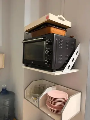 a microwave oven sitting on a shelf in a kitchen at Urban loft in Cordoba