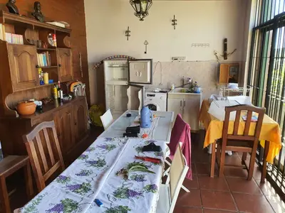 a kitchen with a table and a dining room at Casa en las Sierras de Cordoba in Villa Parque Siquiman