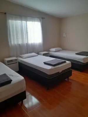a room with two beds and a window at La casa de los abuelos! in Santa María