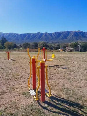 a playground with red and yellow pipes in a field at La casa de los abuelos! in Santa María