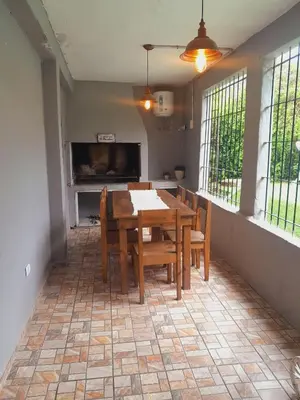 a dining room with a wooden table and chairs at La casa de los abuelos! in Santa María