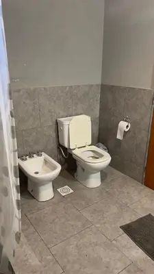 a bathroom with a toilet and a bidet at La Casona Dique Chico in Villa Anizacate