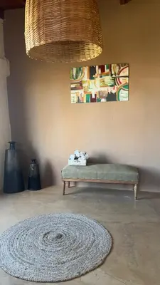 a living room with a bench and a rug at La Casona Dique Chico in Villa Anizacate