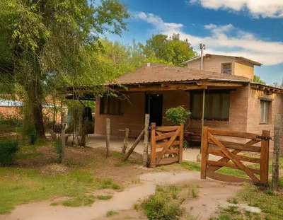 a house with a wooden gate in front of it at Cabaña para 8 en Arroyo de los Patos in Arroyo de Los Patos