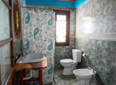 a bathroom with a toilet and a sink at Cabaña para 8 en Arroyo de los Patos in Arroyo de Los Patos