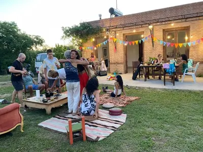 a group of people standing in a yard at Casa de Las Brujas Traslasierra in Los Molles