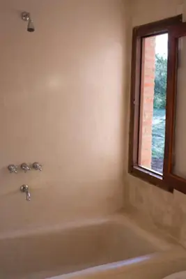 a bath tub in a bathroom with a window at Casa de Las Brujas Traslasierra in Los Molles