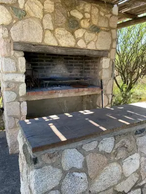 a stone fireplace in a stone wall at Casa de Las Brujas Traslasierra in Los Molles