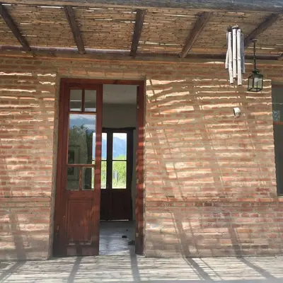 an open door of a building with a brick wall at Casa de Las Brujas Traslasierra in Los Molles