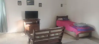 a small bedroom with a bed and a television at Caminito1 in Villa Anizacate