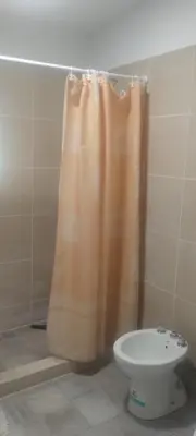a shower curtain in a bathroom with a toilet at Caminito1 in Villa Anizacate