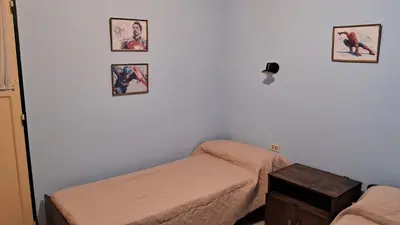 a room with a bed and pictures on the wall at Alojamiento Arroyo de los Patos in Arroyo de Los Patos