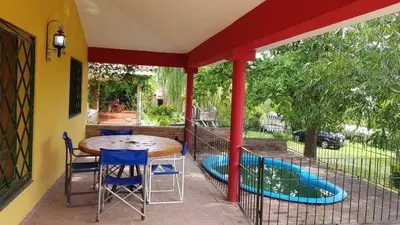 a patio with a table and chairs and a swimming pool at Alojamiento Arroyo de los Patos in Arroyo de Los Patos