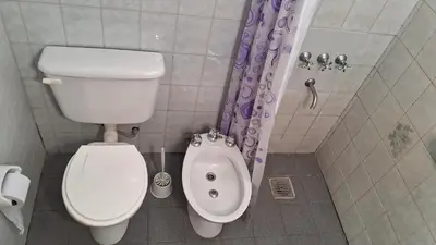 a small bathroom with a toilet and a bidet at Alojamiento Arroyo de los Patos in Arroyo de Los Patos