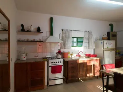 a kitchen with a white stove and a refrigerator at Alojamiento Arroyo de los Patos in Arroyo de Los Patos