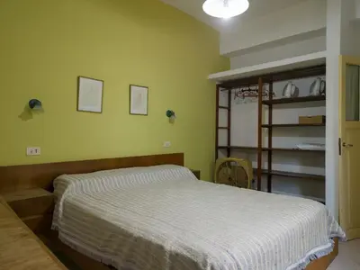 a bedroom with a bed with a white comforter at Alojamiento Arroyo de los Patos in Arroyo de Los Patos