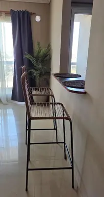 a chair sitting in a room with a plant at Departamento a estrenar deluxe in Cordoba