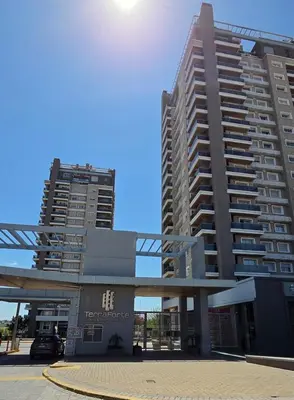 two tall buildings in front of a parking lot at Departamento a estrenar deluxe in Cordoba