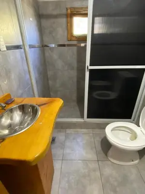 a bathroom with a sink and a toilet at cabaña Mirador in Bialet Massé