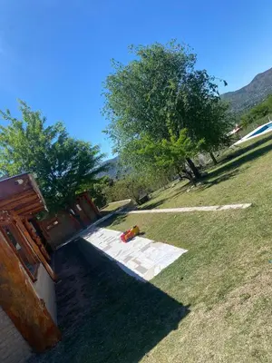 a path in a field with trees in the background at cabaña Mirador in Bialet Massé