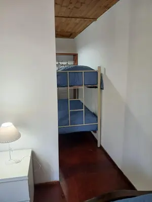 a room with a bunk bed and a desk and a lamp at Terrazas del Kempes- Sanatorio Allende Cerro in Cordoba