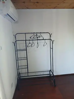 a metal rack with glasses on it in a room at Terrazas del Kempes- Sanatorio Allende Cerro in Cordoba