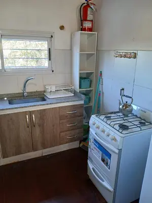 a kitchen with a stove and a sink at Terrazas del Kempes- Sanatorio Allende Cerro in Cordoba
