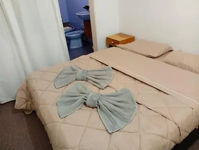 a bedroom with two beds with bows on them at New POSADA SOL in Villa Carlos Paz