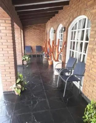 a patio with chairs and cacti in a brick building at New POSADA SOL in Villa Carlos Paz
